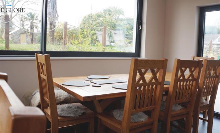 A corner of the dining room, accommodates 24 in one long / u shaped table or 6 separate tables